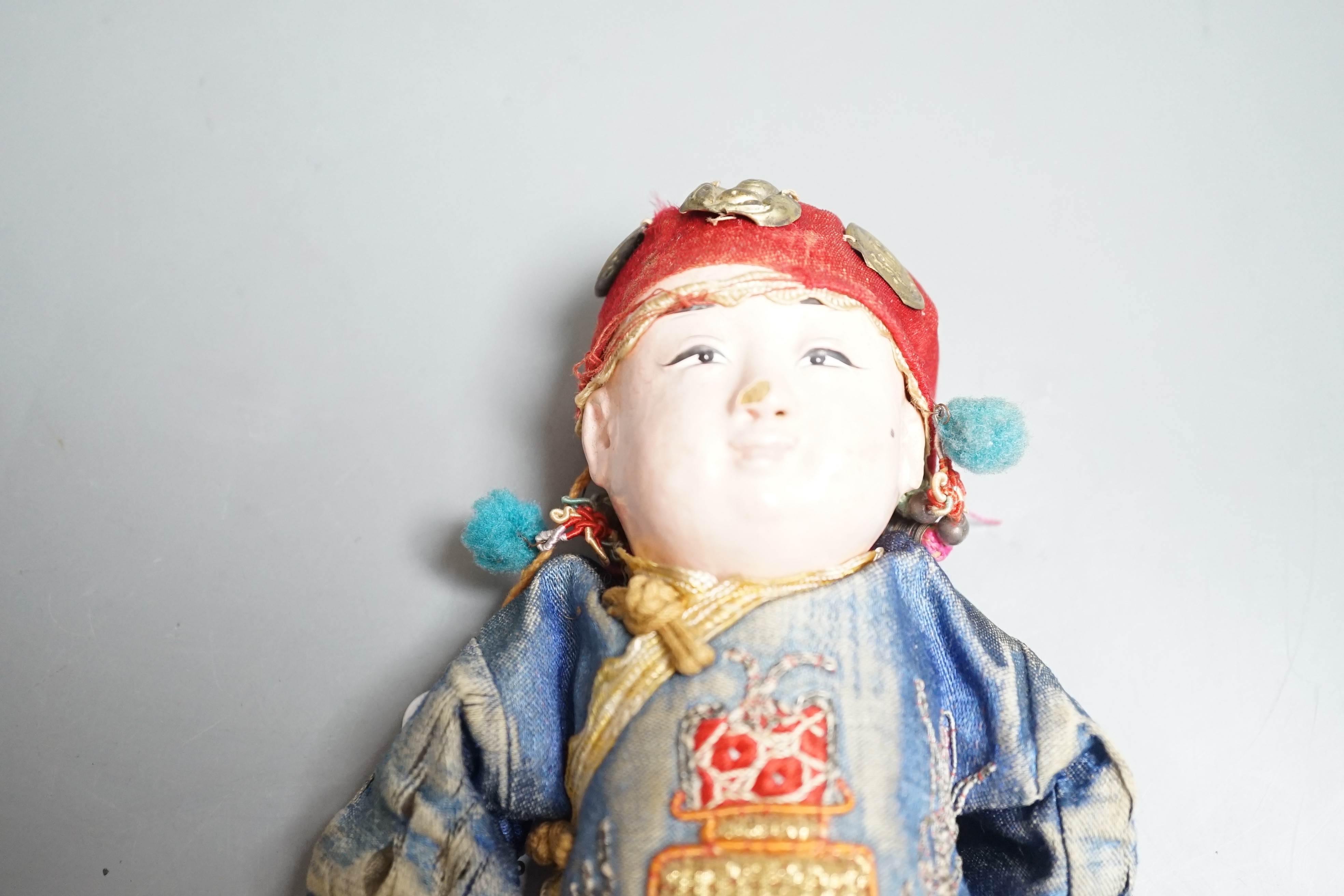 An early 20th century Chinese papier-mâché doll
